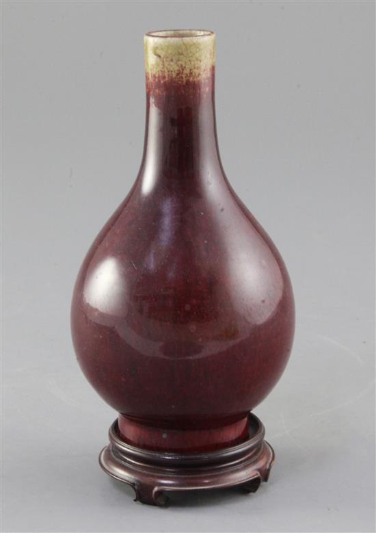 A Chinese Langyao sang de boeuf glazed bottle vase, 18th century, height 15cm. wood stand